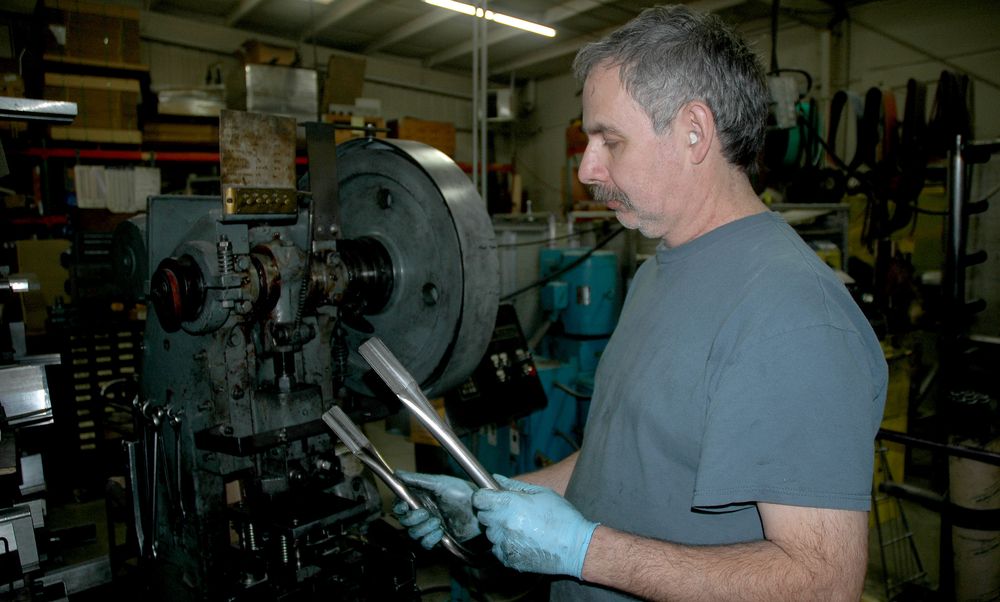 skilled machinist checking quality